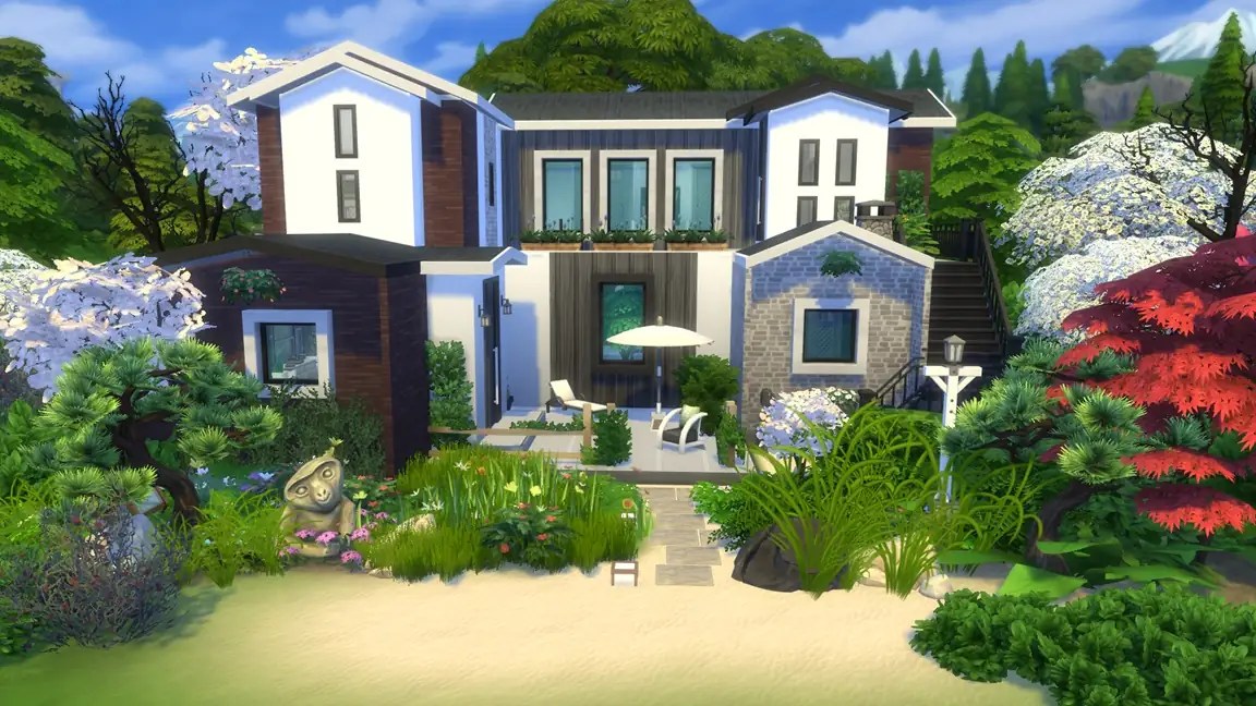 A modern house with a combination of white and dark wood exterior, surrounded by lush greenery and flowering plants. The garden features a small stone statue, a patio with chairs and an umbrella, and stairs leading to an upper level.