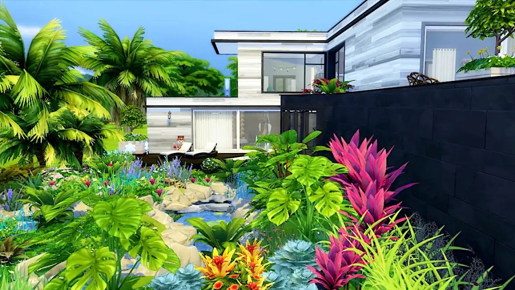 A modern house surrounded by lush tropical plants and flowers, with a small pond and rocky landscaping in the foreground.